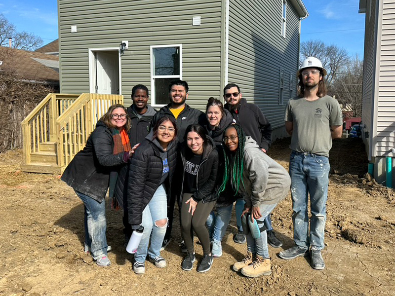 Group of Habitat for Humanity volunteers outside of new Cincinnati home