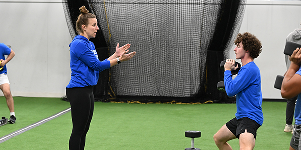 Coach working with a student athlete.