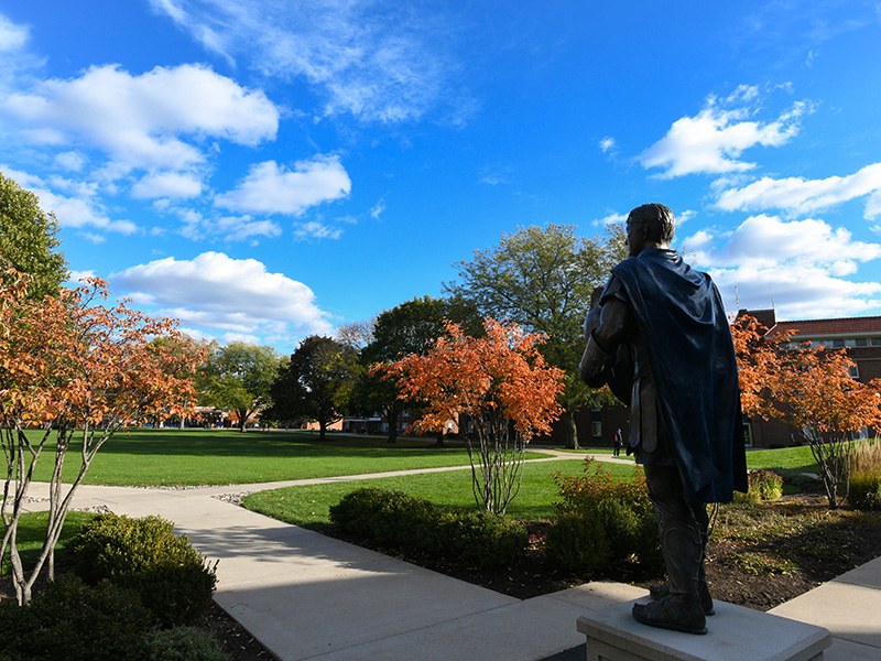 spartan statue overlooking the quad in the fall