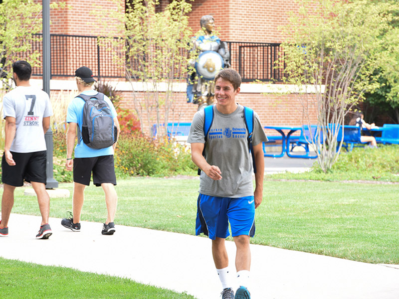 Student walking in quad.