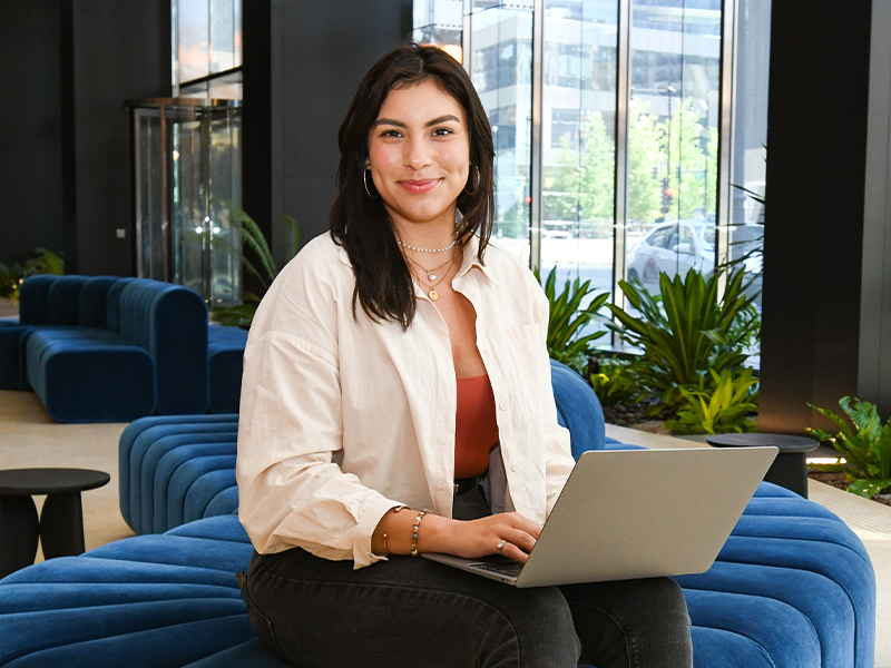 student on computer at a business
