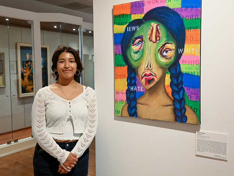 Student artist Jocelyn Olivera ’28 next to her work,
