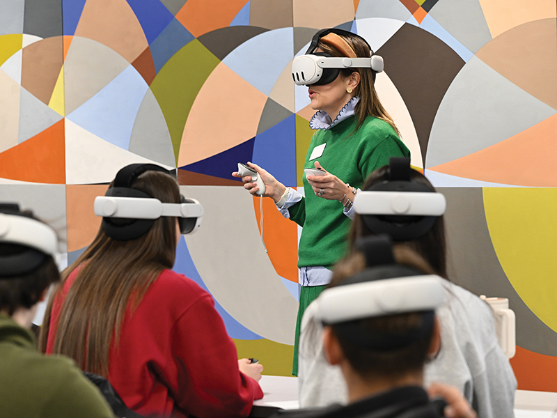 faculty demonstrates using VR headset