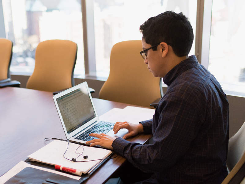 AU student using a laptop.