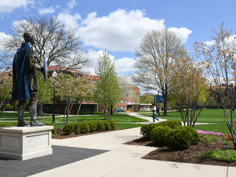 The Spartan Statue overlooks the Quad on a blue-sky, spring day.