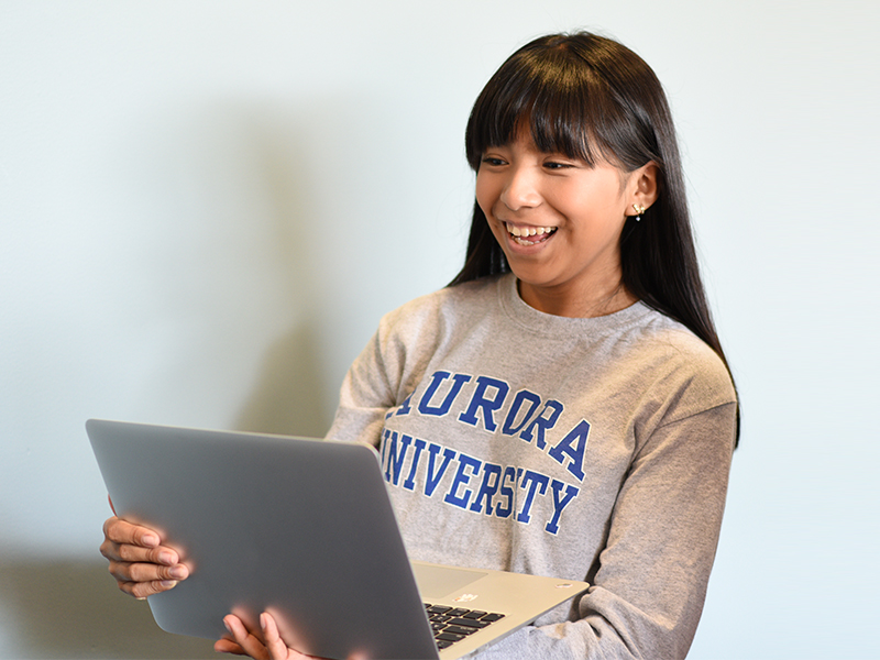 AU student holding a laptop.