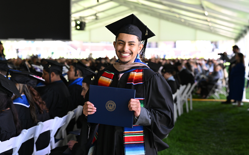 Graduate wearing a cap and gown.