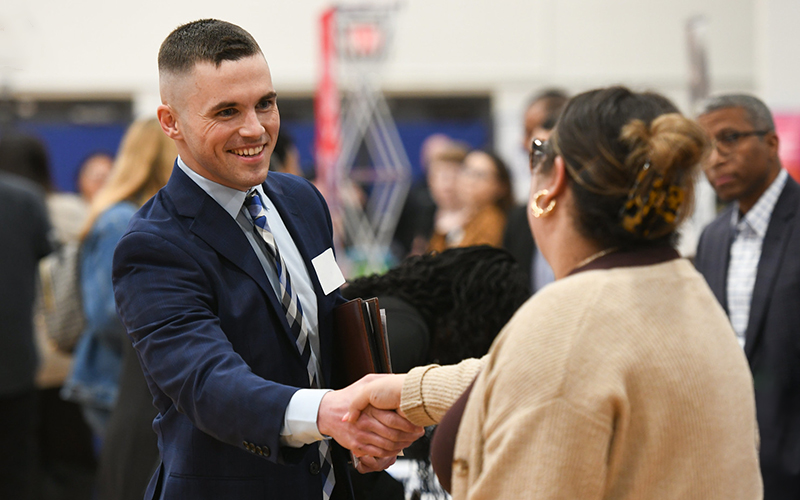 Student shaking hands with an employer at the Career Fair