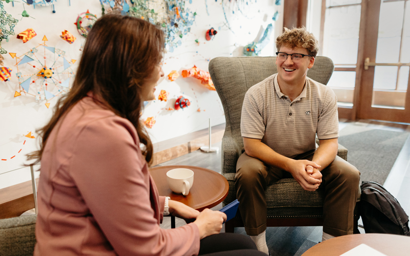 Staff talking to a student.