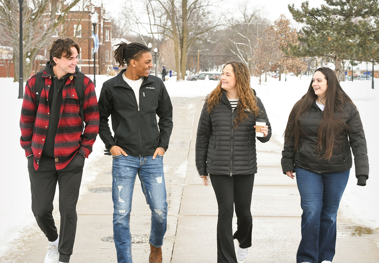Students walking together across a wintry campus.