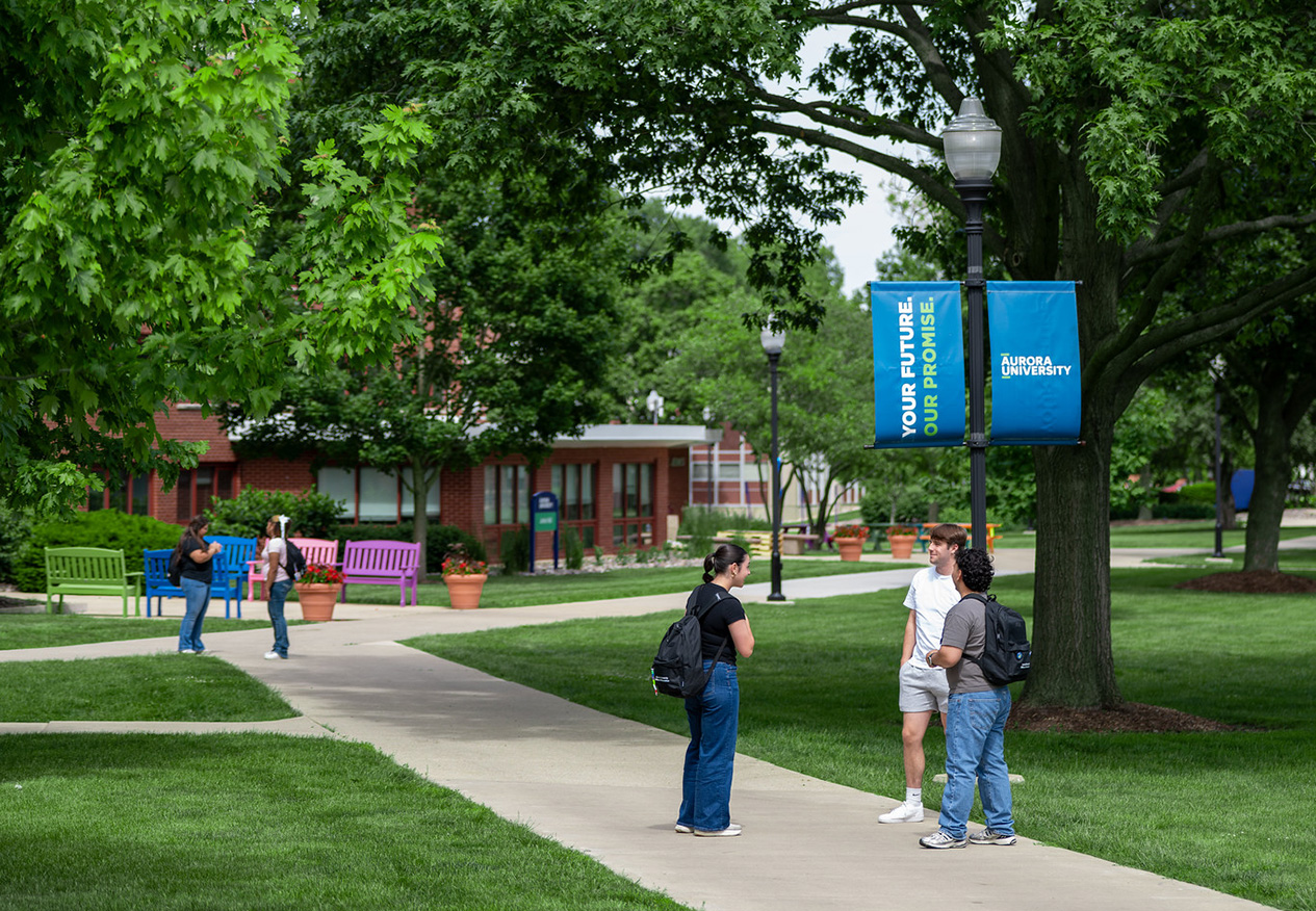 Three AU students talking near the Quad.