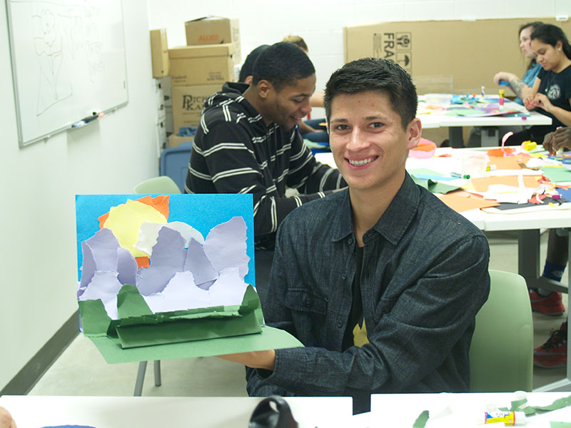 Student Displaying Art Piece