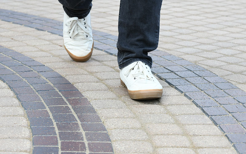 Close up photo of a shoe on a person walking the labyrinth.