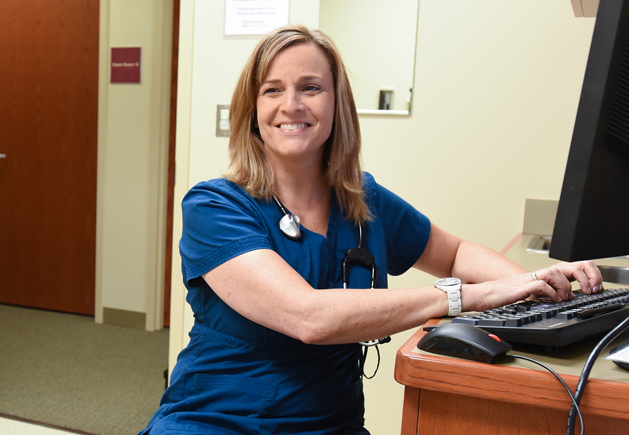 A nurse sitting at a computer