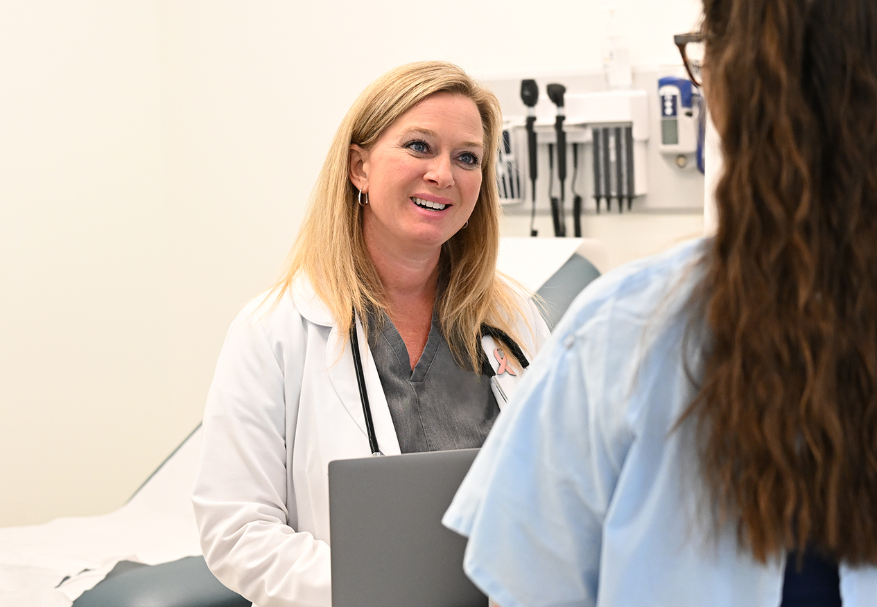 Nurse Practitioner talks to patient in an exam room