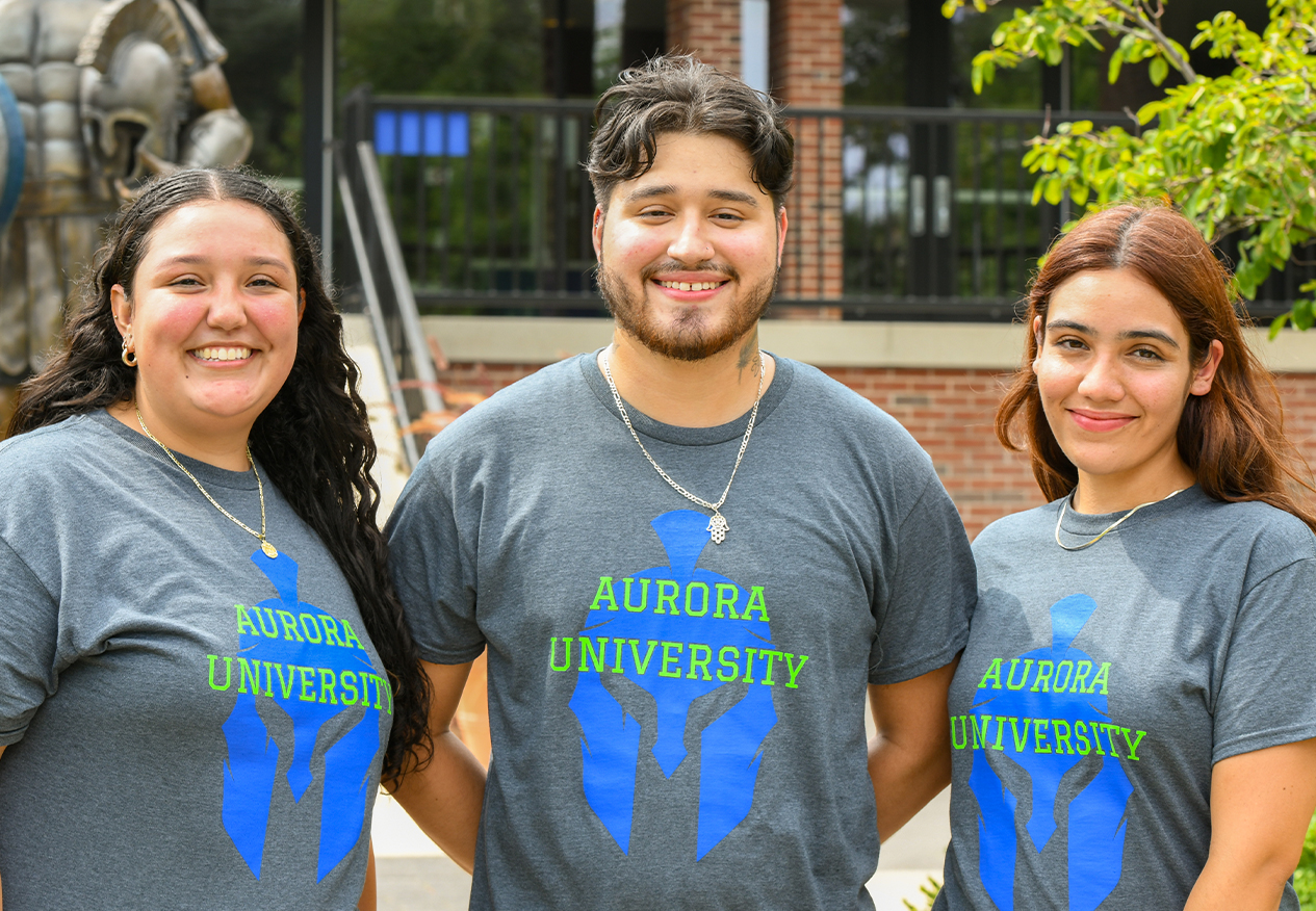 Three students smiling on campus